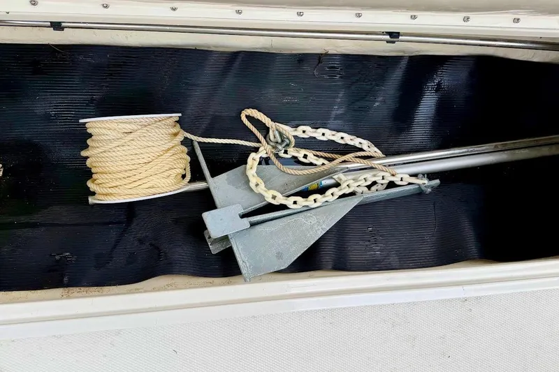 Slide: The Image of Anchor and rope stored in a 2020 Sea Ray SPX 210 Outboard boat compartment. - 33