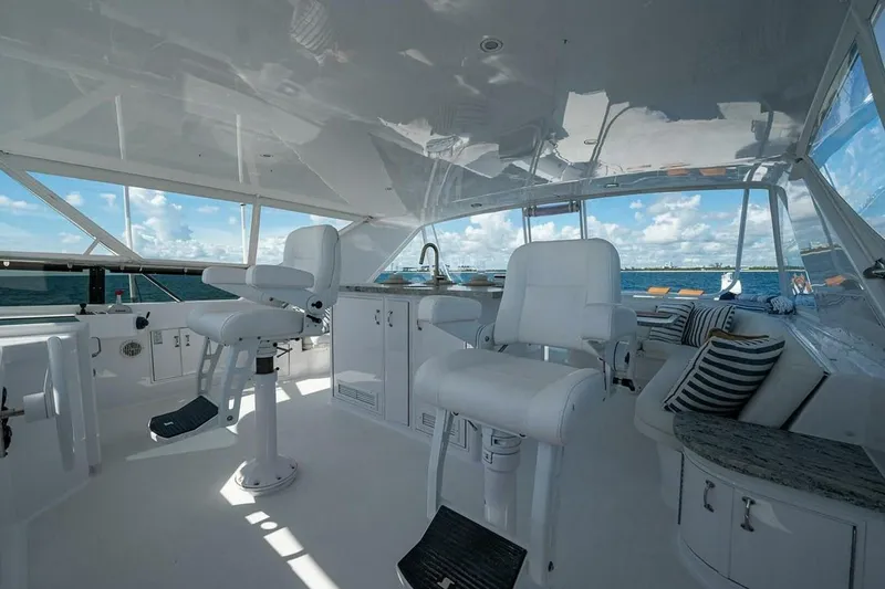 Slide: The Image of Luxurious 2003 Hatteras 100 Raised Pilothouse yacht interior with white seating and ocean view. - 16