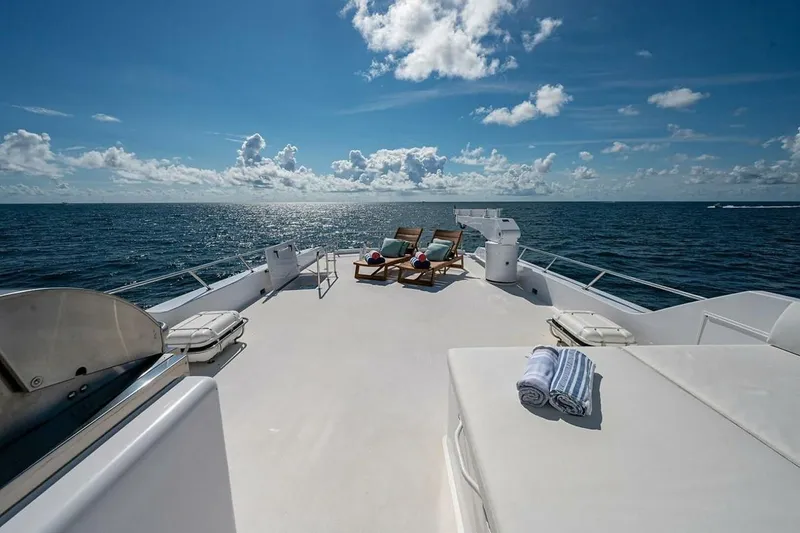 Slide: The Image of Luxurious deck of 2003 Hatteras 100 Raised Pilothouse yacht with ocean view and lounge chairs. - 17