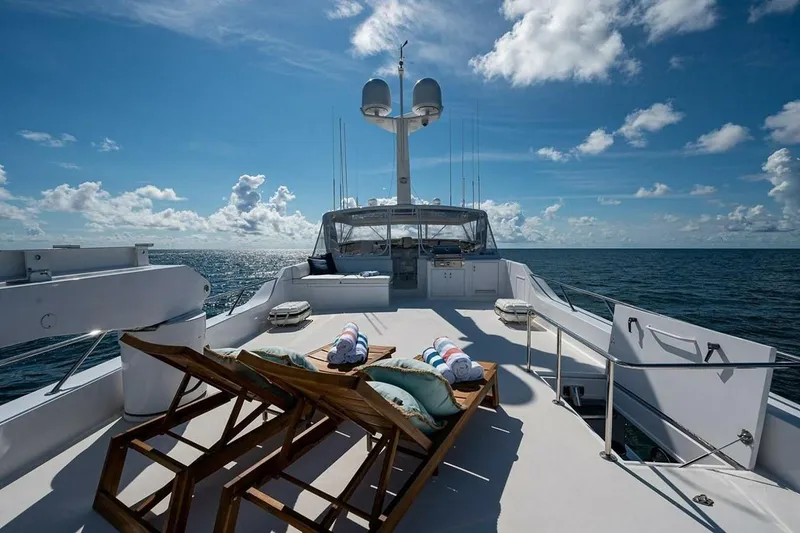 Slide: The Image of Luxurious 2003 Hatteras 100 Raised Pilothouse yacht deck with sun loungers and ocean view. - 18
