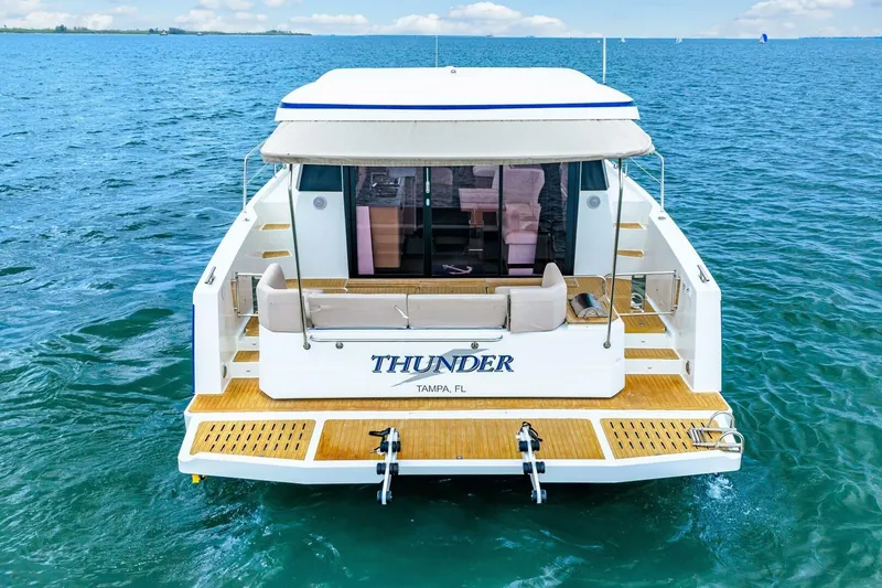 Slide: The Image of 2021 Fountaine Pajot MY4.S yacht named "Thunder" on open water, rear view. - 112