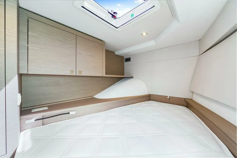 Slide: The Image of 2021 Fountaine Pajot MY4.S cabin interior with modern wood finish and skylight. - 27
