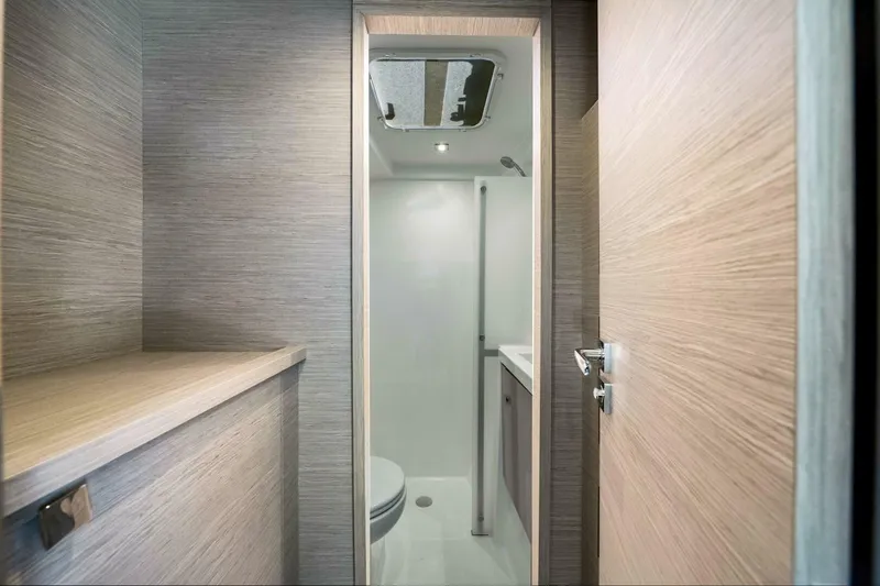 Slide: The Image of Modern bathroom interior on 2021 Fountaine Pajot MY4.S yacht, featuring sleek wood finishes. - 31