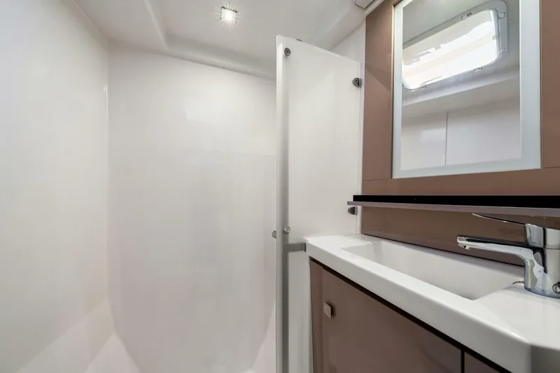 Slide: The Image of Modern bathroom interior on 2021 Fountaine Pajot MY4.S yacht, featuring sleek sink and mirror. - 32