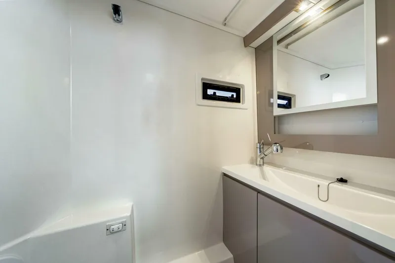 Slide: The Image of Modern bathroom interior of 2021 Fountaine Pajot MY4.S yacht, featuring sleek sink and mirror. - 33