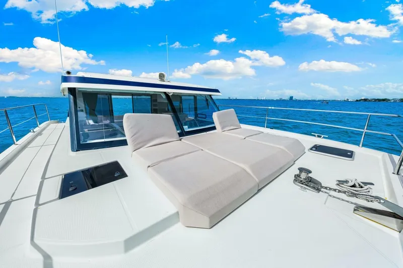 Slide: The Image of 2021 Fountaine Pajot MY4.S yacht deck with sun loungers, ocean view, and blue sky. - 39
