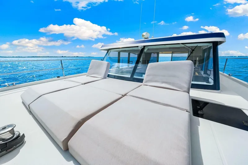 Slide: The Image of 2021 Fountaine Pajot MY4.S yacht with sun loungers on deck, under a clear blue sky. - 40