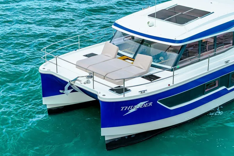 Slide: The Image of 2021 Fountaine Pajot MY4.S yacht on turquoise water, featuring sleek design and spacious deck. - 65