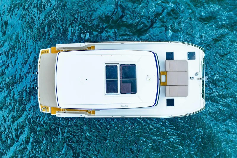 Slide: The Image of Top view of 2021 Fountaine Pajot MY4.S yacht on blue water. - 77