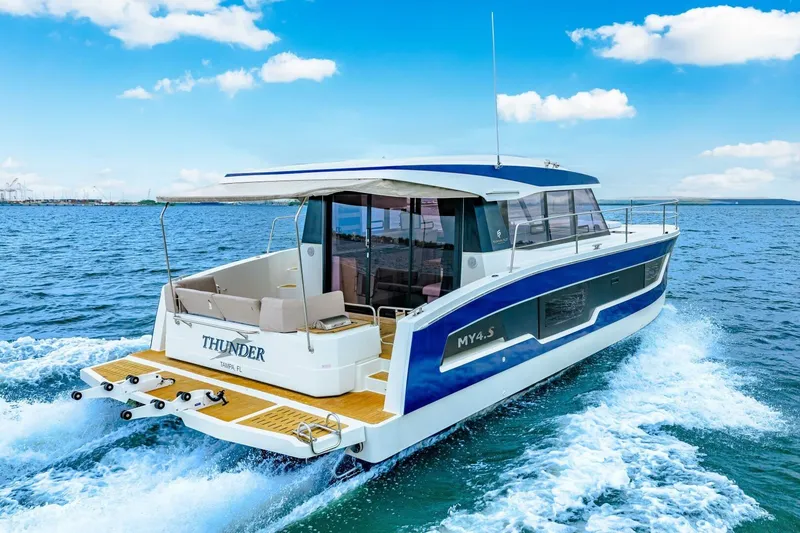 Slide: The Image of 2021 Fountaine Pajot MY4.S yacht cruising on open water, rear view. - 85
