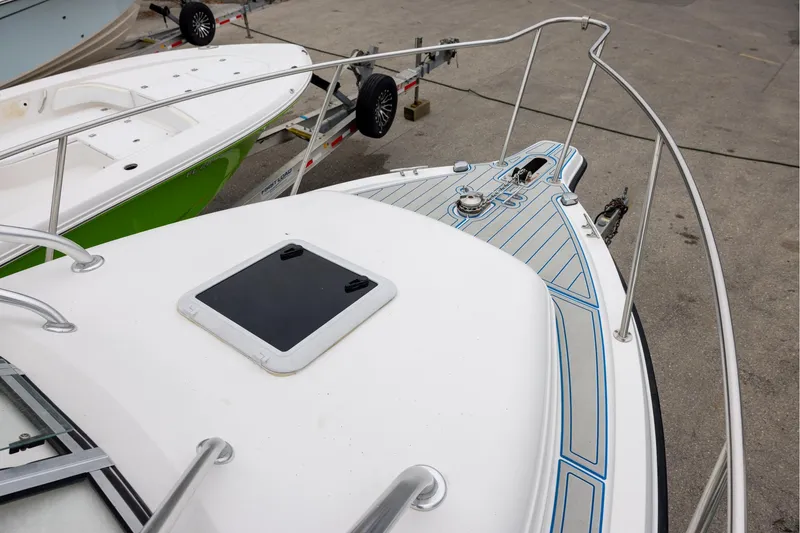 Slide: The Image of 2008 Century 2400 Walk-Around boat with sleek deck design and railing. - 12