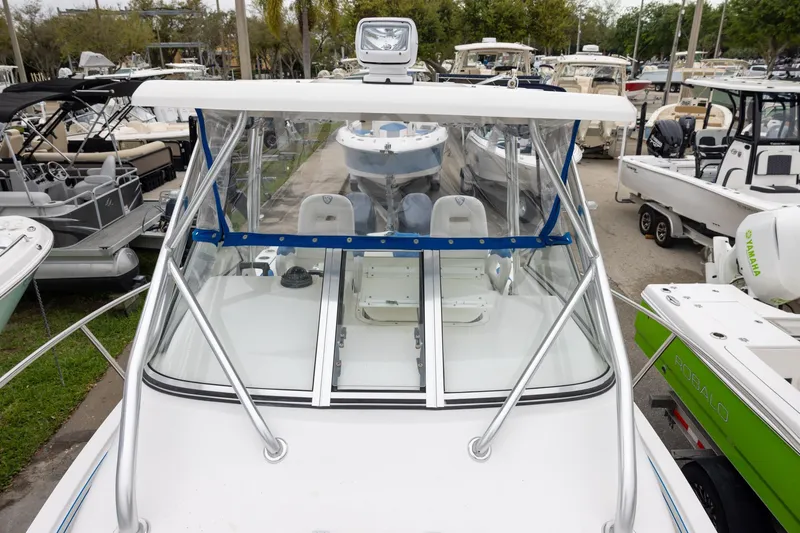 Slide: The Image of 2008 Century 2400 Walk-Around boat with clear windshield, docked among other boats. - 13