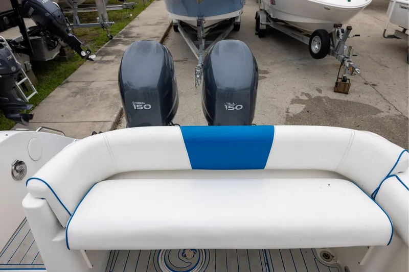 Slide: The Image of 2008 Century 2400 Walk-Around boat with Yamaha 150 engines, featuring white and blue seating. - 6