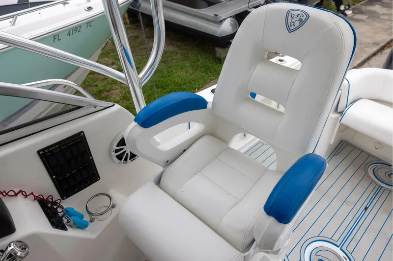 Slide: The Image of Captain's chair on a 2008 Century 2400 Walk-Around boat, featuring blue accents. - 8