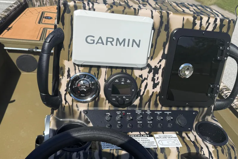 Slide: The Image of Control panel of 2026 Avid 18 Rogue CC boat with Garmin navigation system. - 12