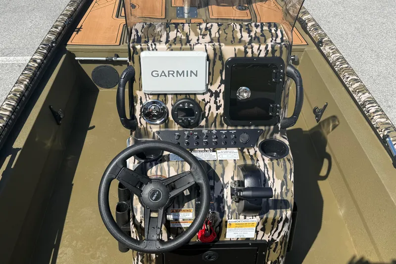 Slide: The Image of 2026 Avid 18 Rogue CC boat console with Garmin navigation system and camouflage design. - 13