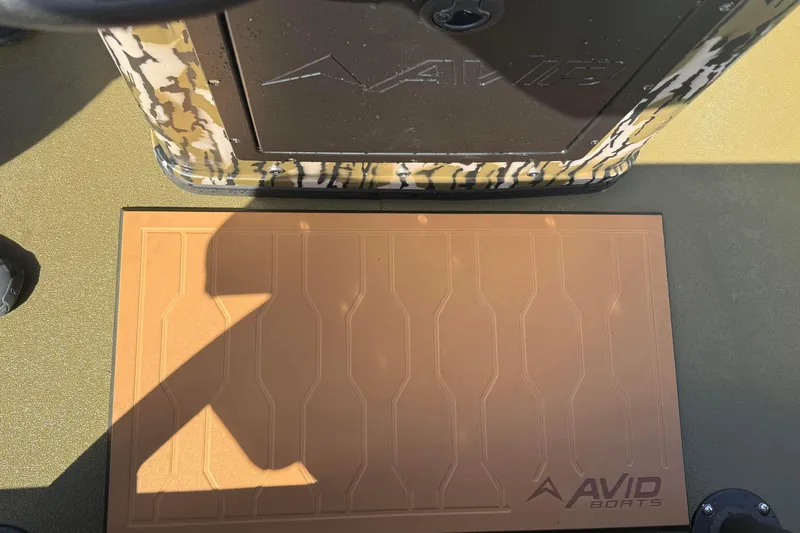 Slide: The Image of 2026 Avid 18 Rogue CC boat deck with camouflage design and branded mat. - 14