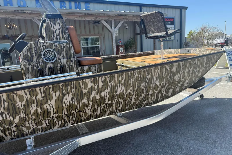 Slide: The Image of 2026 Avid 18 Rogue CC boat with camouflage design on a trailer. - 3