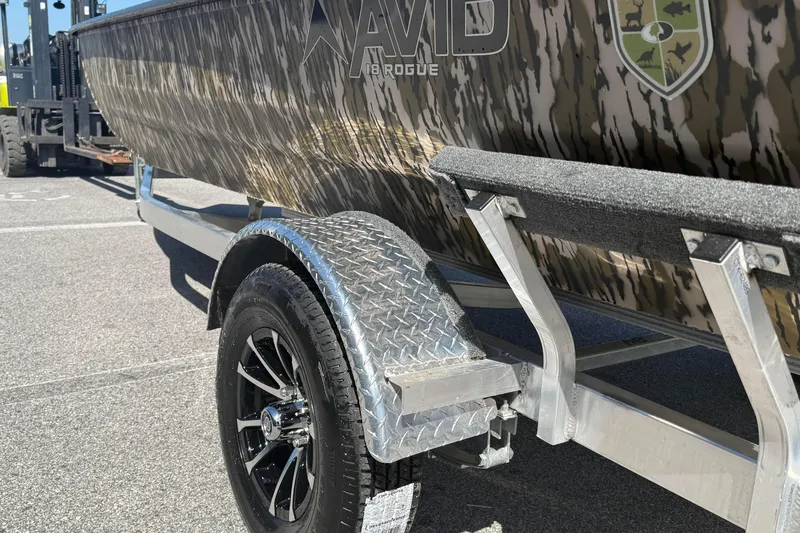 Slide: The Image of 2026 Avid 18 Rogue CC boat on a trailer with camouflage design. - 7