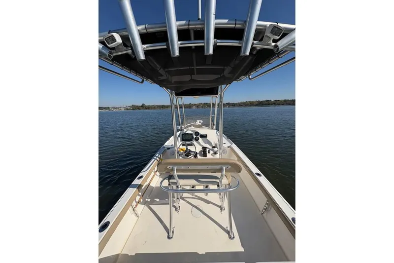 Slide: The Image of 2016 KEYWEST 210 BR boat on calm water, featuring a T-top and console. - 10