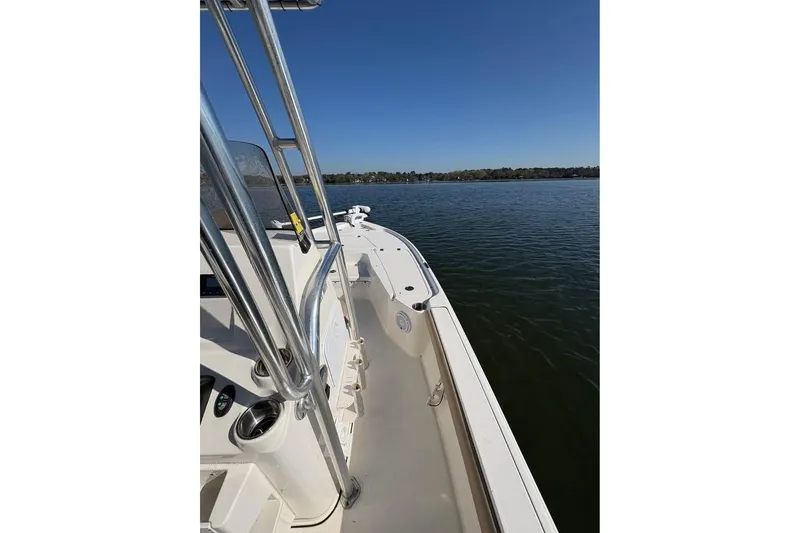Slide: The Image of 2016 KEYWEST 210 BR boat on calm water under clear blue sky. - 11