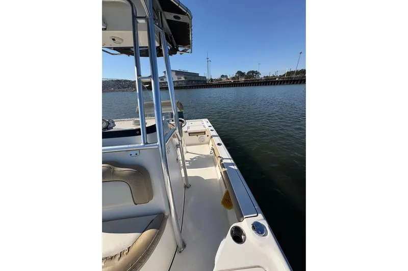 Slide: The Image of 2016 KEYWEST 210 BR boat docked by calm waters under clear blue sky. - 12