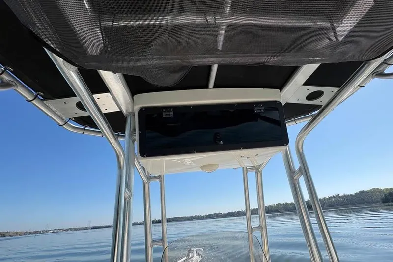 Slide: The Image of 2016 KEYWEST 210 BR boat canopy and console on calm water. - 15