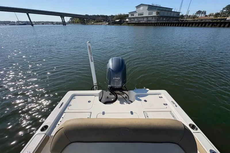 Slide: The Image of 2016 KEYWEST 210 BR boat with outboard motor on calm water near a bridge. - 7