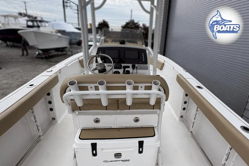 Slide: The Image of 2019 Sportsman Open 232 Center Console boat interior with steering wheel and rod holders. - 10