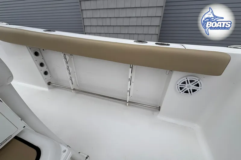 Slide: The Image of 2019 Sportsman Open 232 Center Console boat interior with rod holders and speaker. - 12