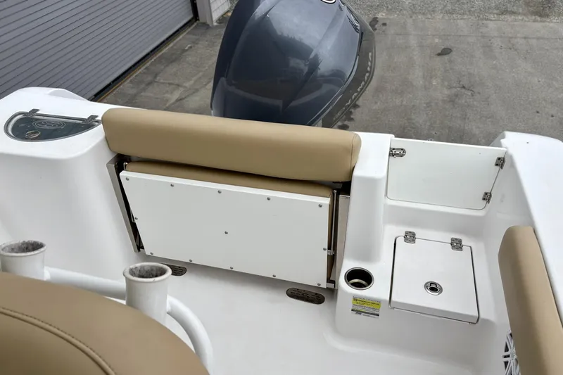 Slide: The Image of 2019 Sportsman Open 232 Center Console boat interior with seating and storage compartments. - 13