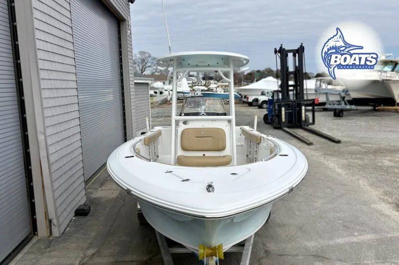 Slide: The Image of 2019 Sportsman Open 232 Center Console boat displayed outdoors near storage facility. - 3