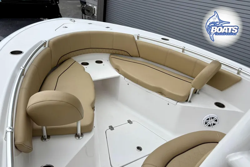 Slide: The Image of 2019 Sportsman Open 232 Center Console boat with tan seating and spacious deck layout. - 6