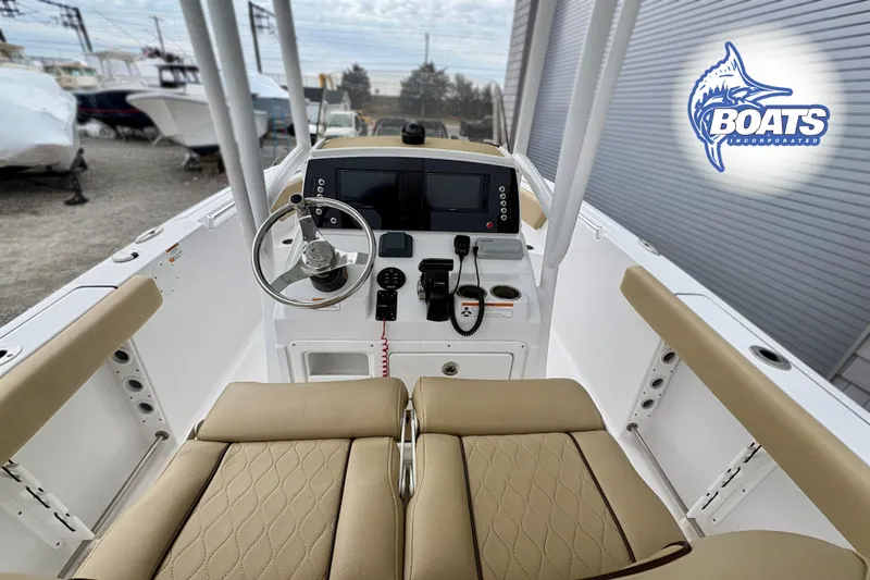 Slide: The Image of 2019 Sportsman Open 232 Center Console boat interior with steering wheel and navigation system. - 9