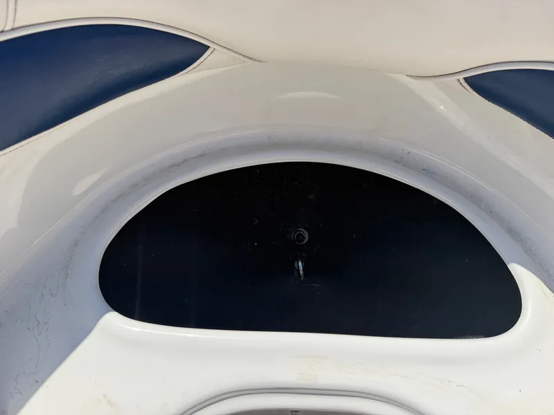 Slide: The Image of Close-up of a white boat seat with blue accents and a black storage compartment. - 34