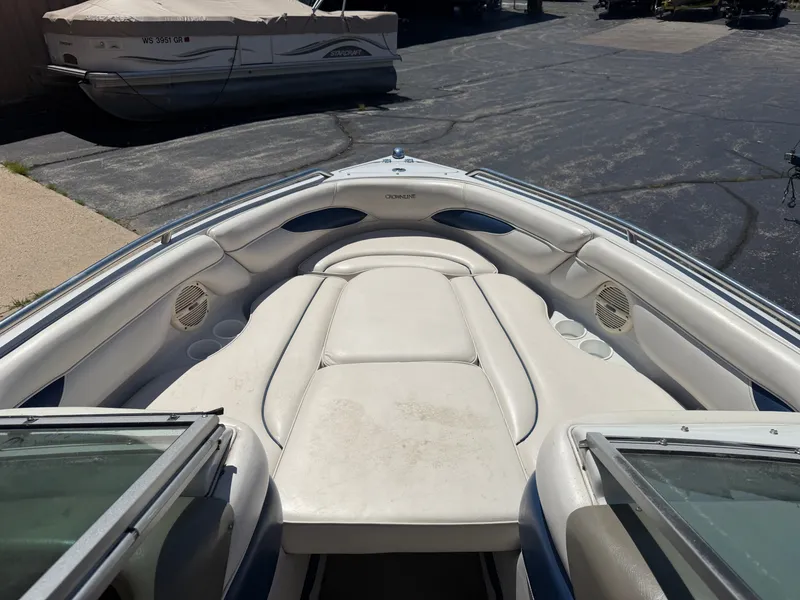 Slide: The Image of The image shows the bow area of a 2002 Crownline 202 BR boat with white upholstery. - 31
