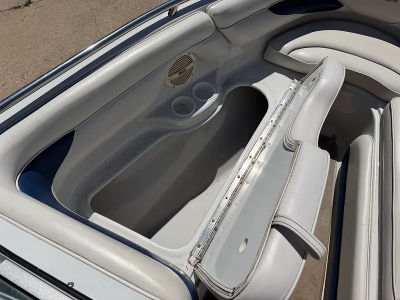 Slide: The Image of The image shows the interior of a 2002 Crownline 202 BR boat with white upholstery. - 33