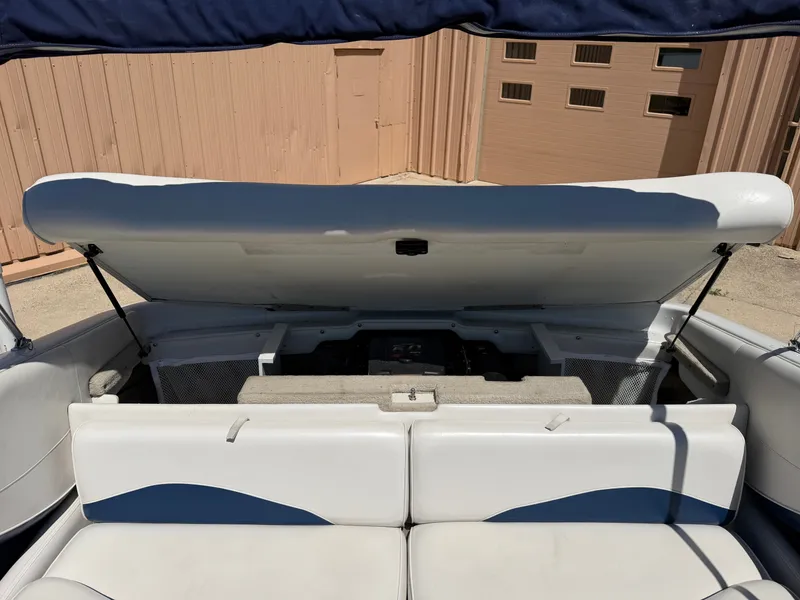 Slide: The Image of The image shows the open engine compartment of a 2002 Crownline 202 BR boat. - 13