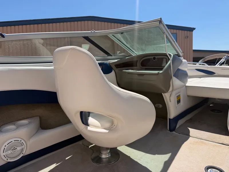 Slide: The Image of The image shows the cockpit of a 2002 Crownline 202 BR with beige and blue interior. - 18
