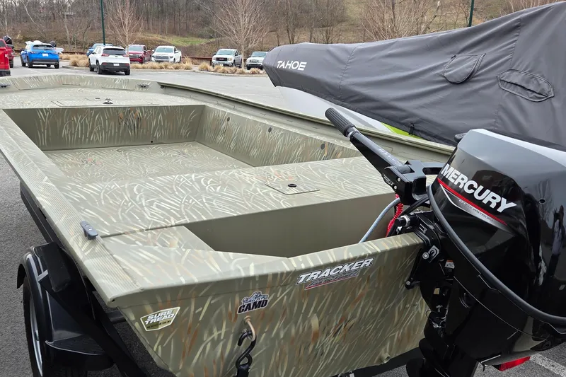 Slide: The Image of 2025 Tracker Grizzly 1754 AWL boat with Mercury engine in parking lot. - 3