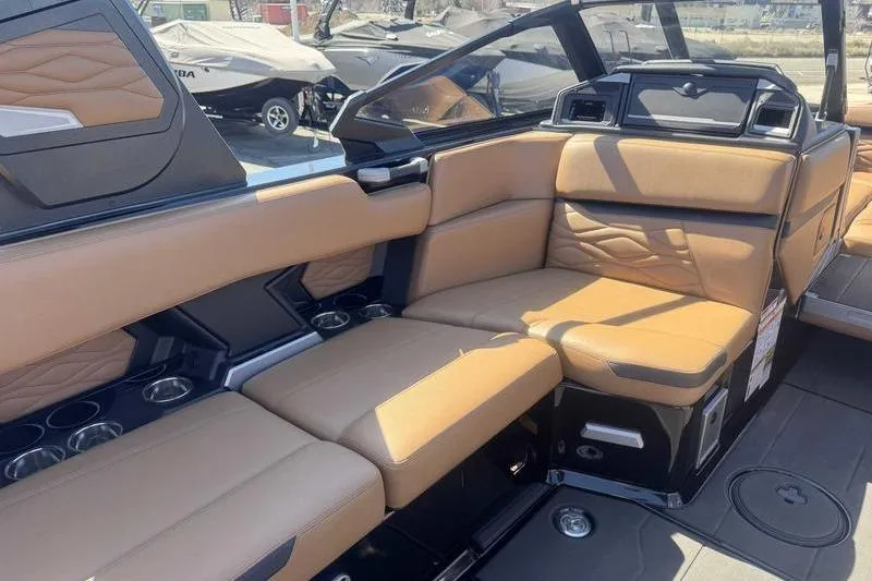 Slide: The Image of Luxurious interior of 2025 Supra SA boat with tan leather seating and cup holders. - 10