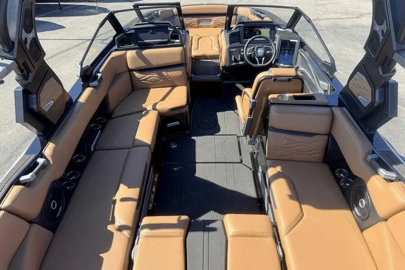 Slide: The Image of Luxurious interior of 2025 Supra SA boat with tan leather seating and modern dashboard. - 11