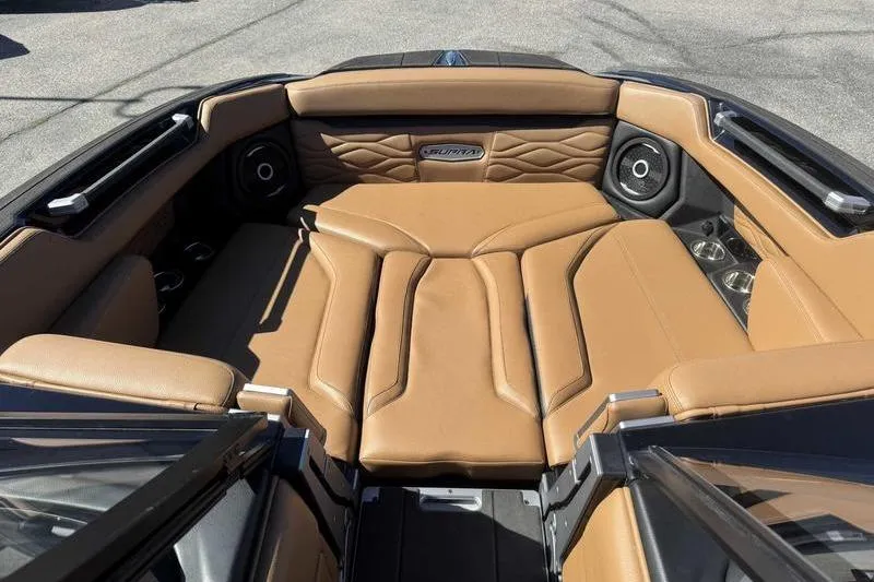 Slide: The Image of Luxurious interior of 2025 Supra SA boat with tan leather seating and premium speakers. - 12