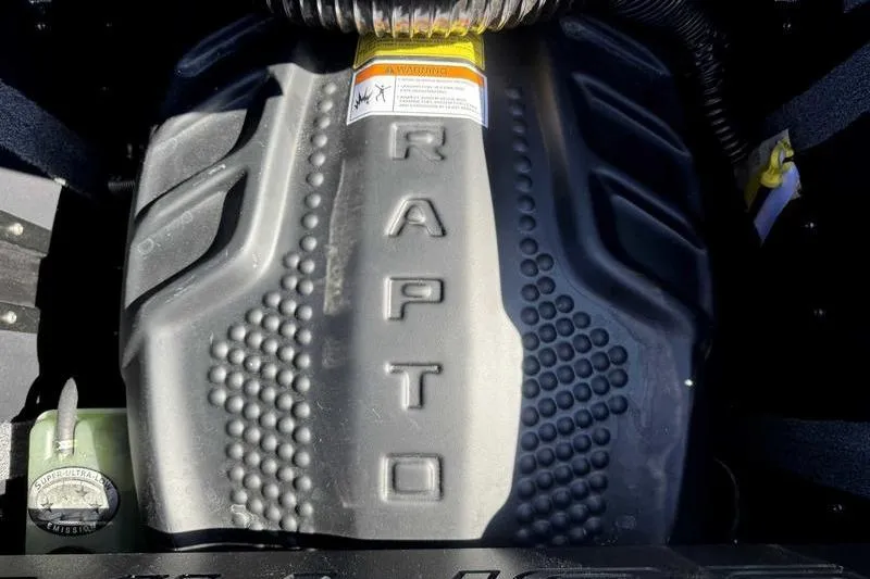 Slide: The Image of 2025 Supra SA engine cover with 'RAPTO' branding and warning label. - 3