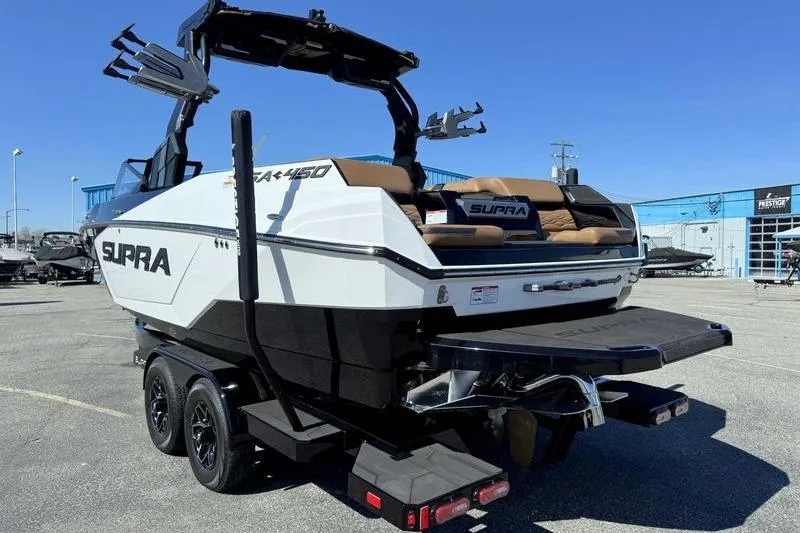 Slide: The Image of 2025 Supra SA boat on trailer, featuring sleek design and modern amenities. - 9