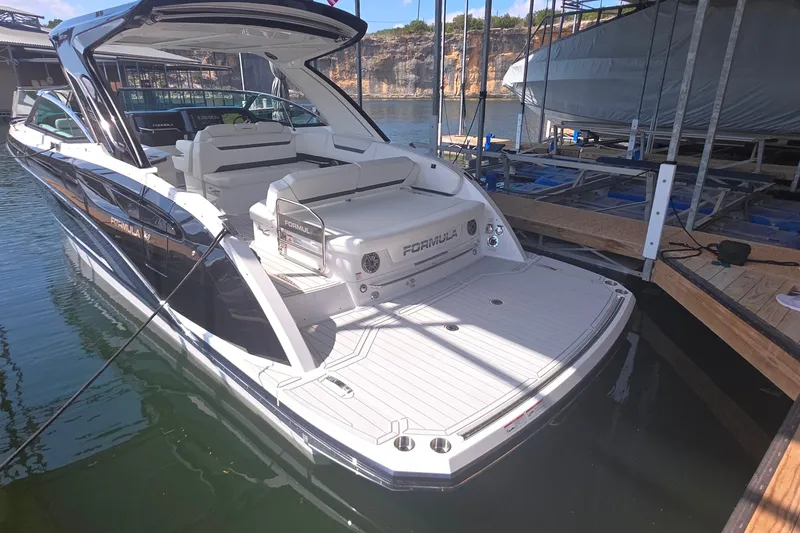 Slide: The Image of 2026 Formula 360 Crossover Bowrider I/O docked, showcasing sleek design and spacious deck. - 10