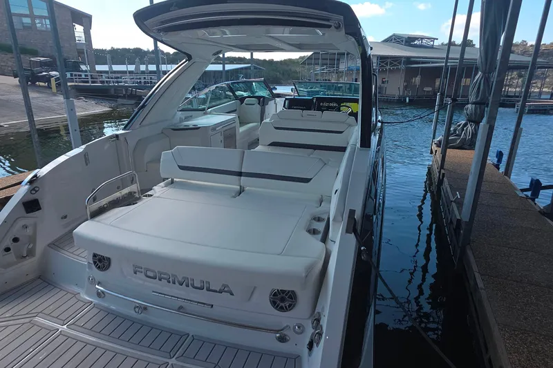 Slide: The Image of 2026 Formula 360 Crossover Bowrider I/O docked, showcasing spacious seating and sleek design. - 12