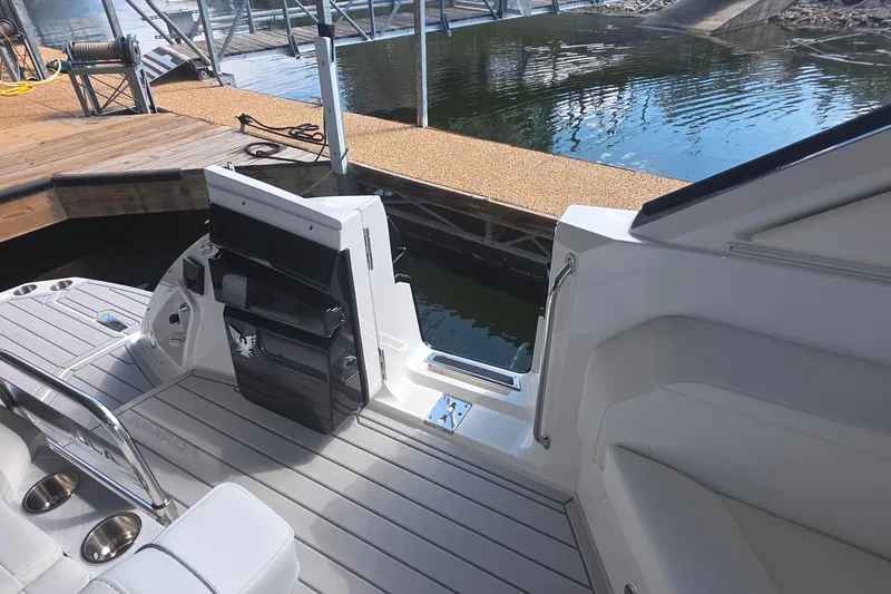 Slide: The Image of 2026 Formula 360 Crossover Bowrider I/O at dock, showcasing sleek interior and water access. - 13