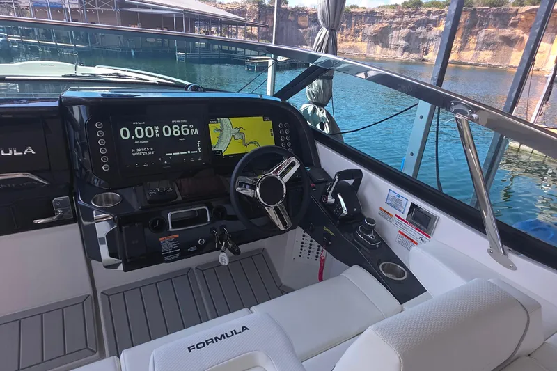 Slide: The Image of 2026 Formula 360 Crossover Bowrider I/O dashboard with navigation screens and steering wheel. - 23