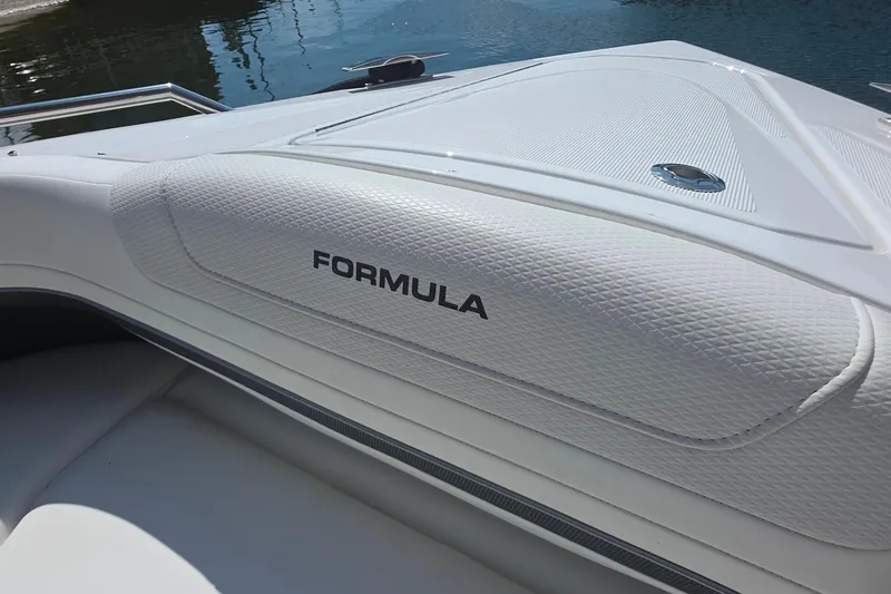 Slide: The Image of 2026 Formula 360 Crossover Bowrider I/O, sleek white design, docked by water. - 28